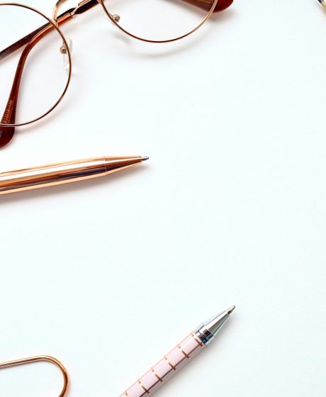 Twist pen beside eyeglasses